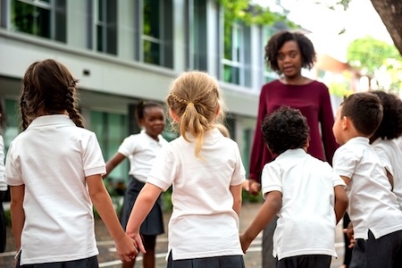 A group of school children holding hands