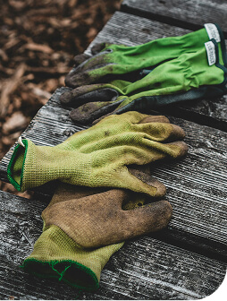 Two sets of used gardening gloves